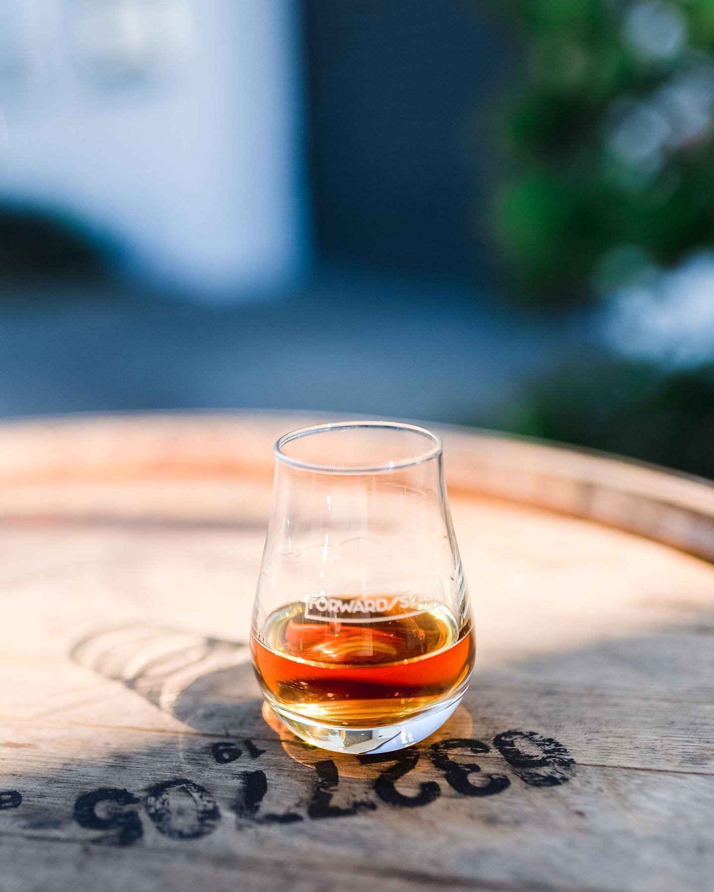 Glass of whiskey on barrel